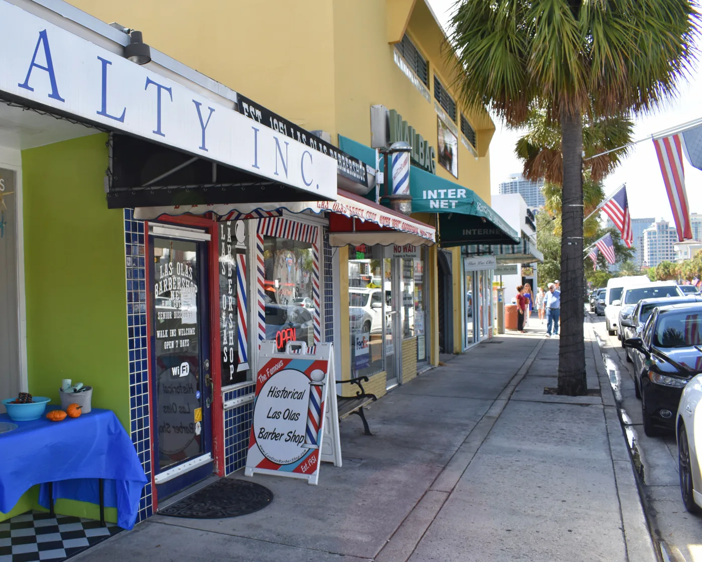 Storefronts on Las Olas Boulevard in Fort Lauderdale, including the Historical Las Olas Barber Shop.