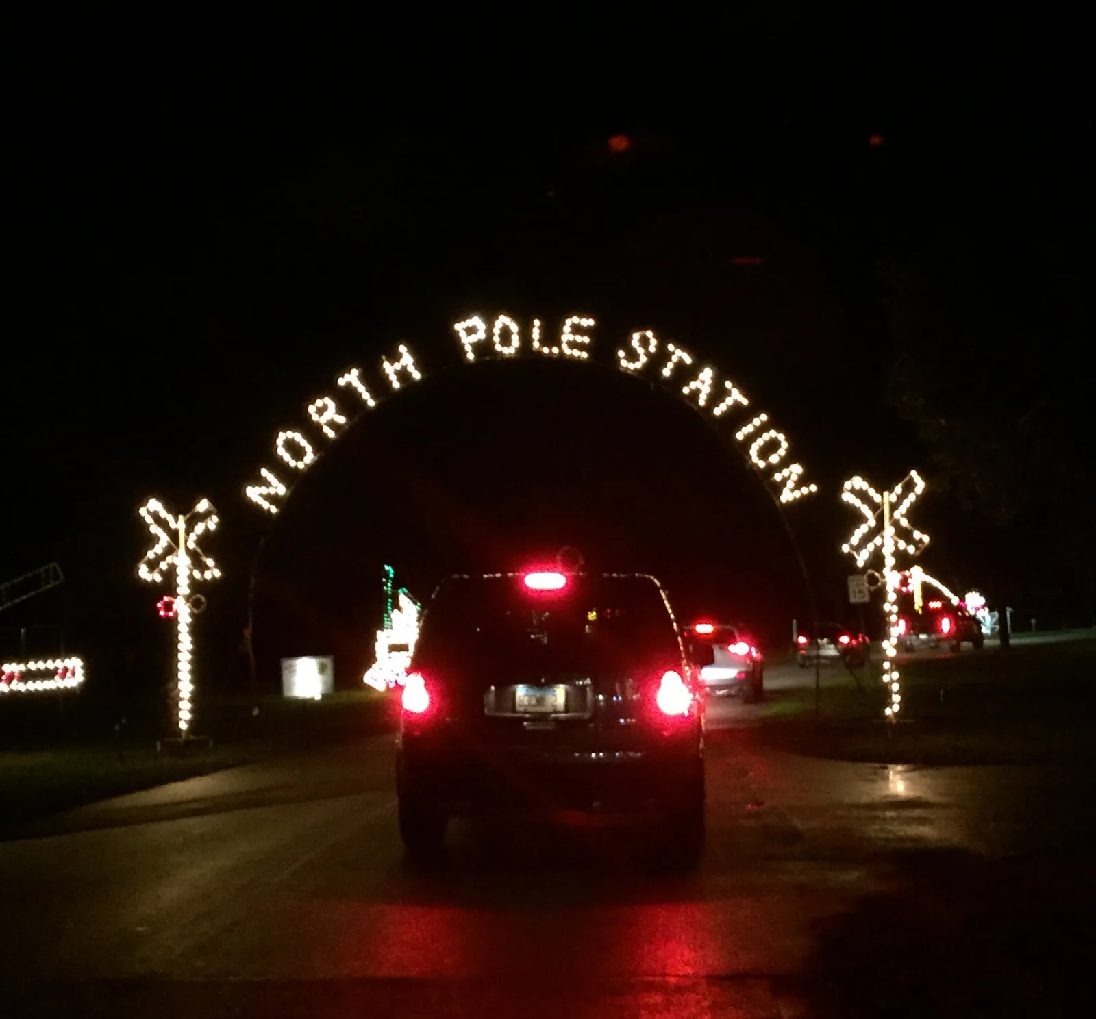 Cars pass under the North Pole Station arch at the Holiday Fantasy of Lights in Tradewinds Park, Coconut Creek.