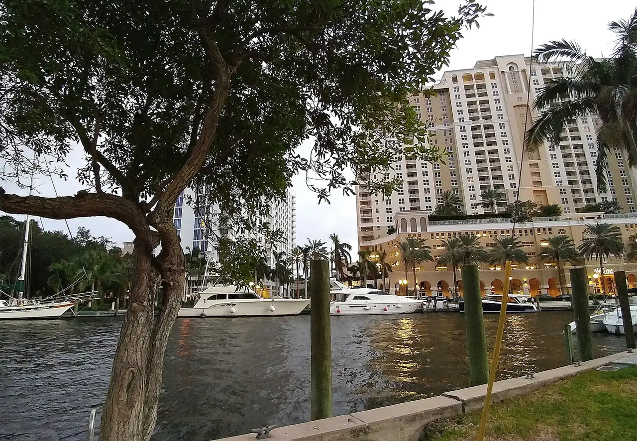 Boats moored along the New River beside the Riverwalk in downtown Fort Lauderdale.