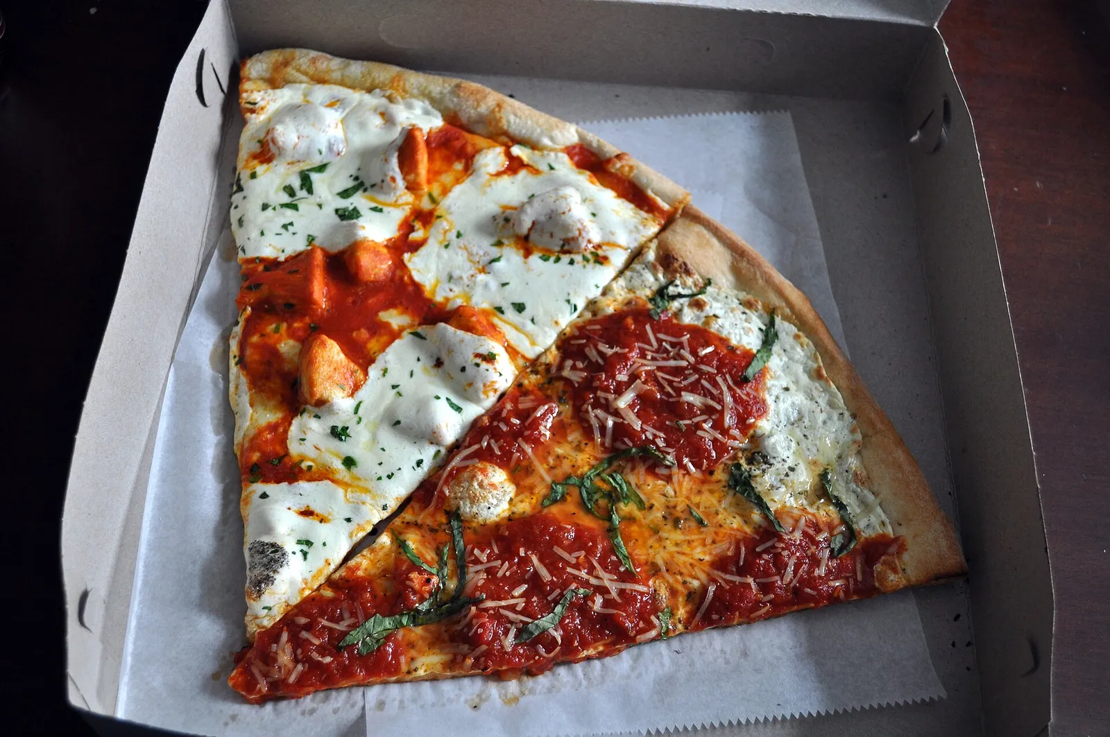 A Buffalo slice and a margherita slice of pizza. The photo was not taken at a Fort Lauderdale restaurant.
